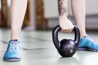 Person styrketränar med vikter